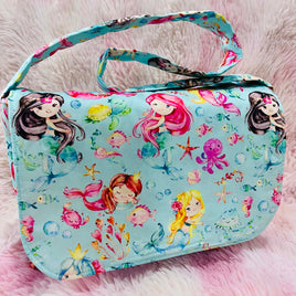 Colorful bag with mermaid design on a pink fluffy background