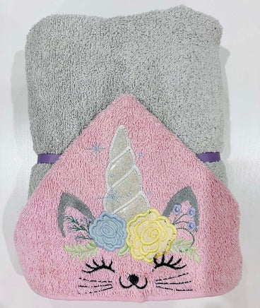 Pink towel with unicorn and cat design on a white background